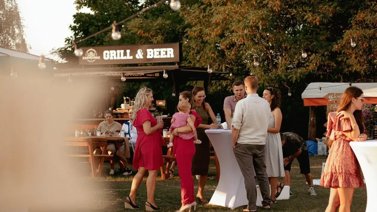 Ludzie na przyjęciu urodzinowym przy grillu i piwie.
