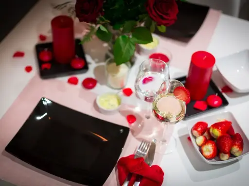 Romantyczna kolacja walentynkowa: czerwone róże, świece, wino i truskawki. Idealne inspiracje, co ugotować na walentynki.