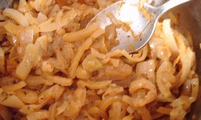 Smażona cebula z przyprawami, wygląda jak pyszna omasta do pierogów.