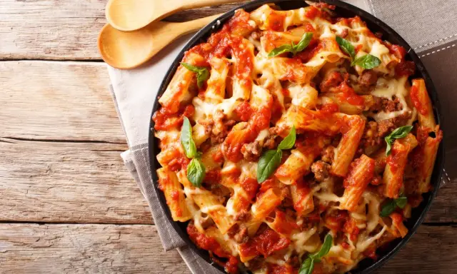 Pyszne danie z makaronem rigatoni, sosem pomidorowym i mięsem mielonym, zapieczone z serem. Idealne co na obiad z mięsa mielonego.