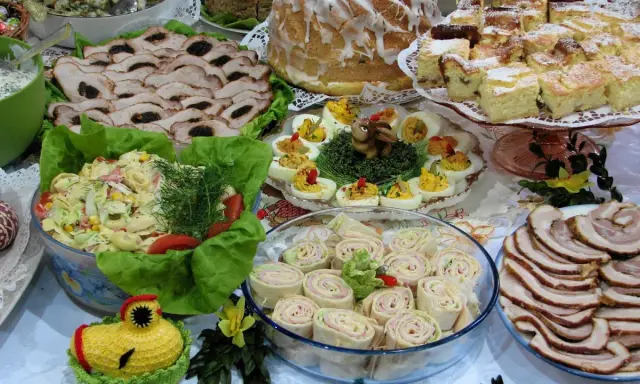 Mnóstwo pyszności na stole, idealnych na to, co ugotować na święta: pieczone mięsa, sałatki, jajka faszerowane, babka i ciasta.
